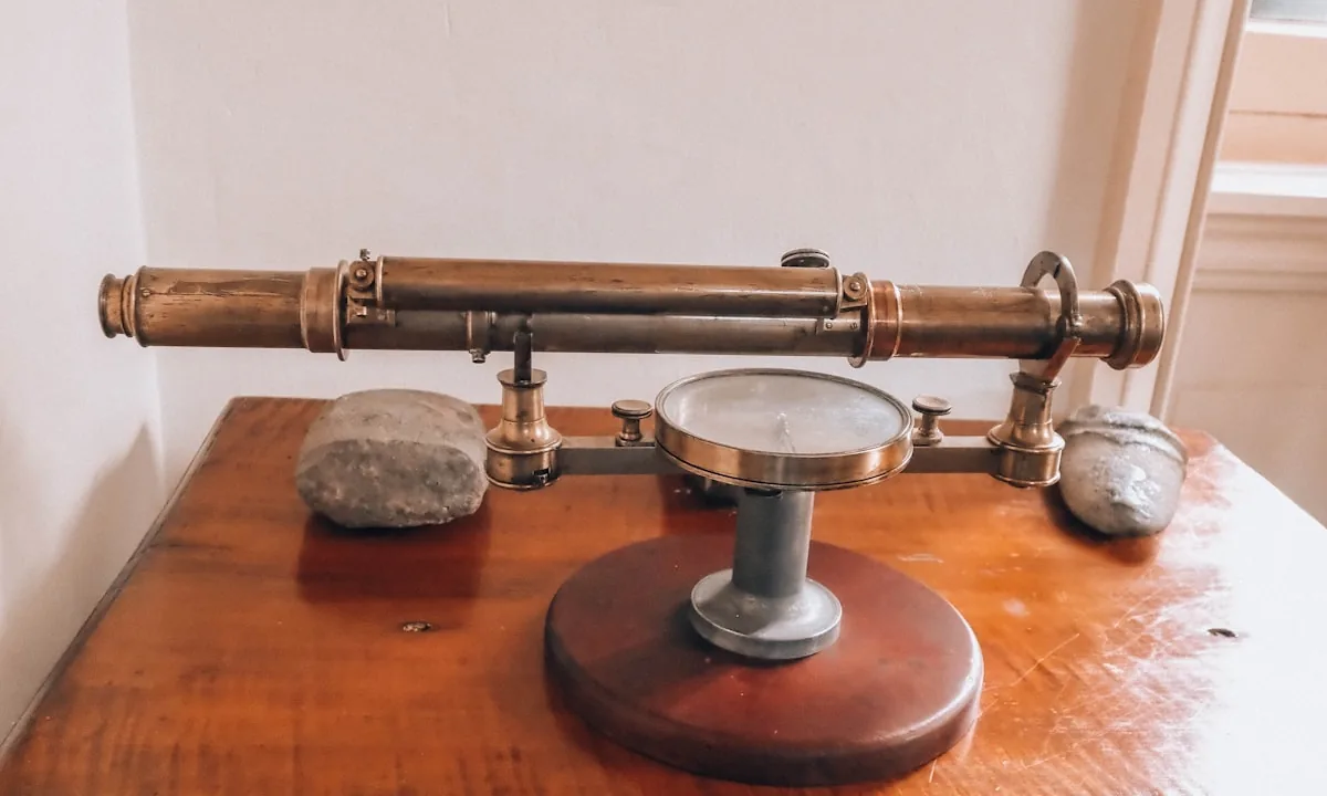 Traditional brass weighing scales representing the economic balance of AI models.