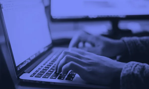 Person deeply focused on their laptop screen
