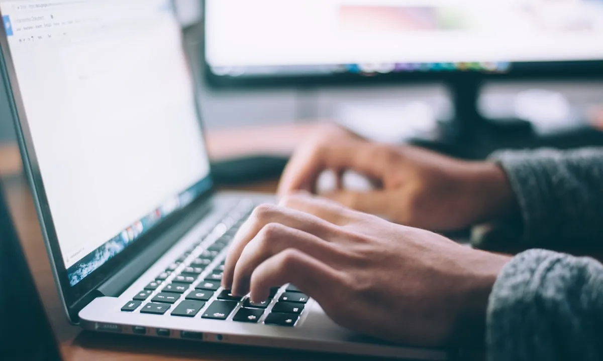 Person deeply focused on their laptop screen