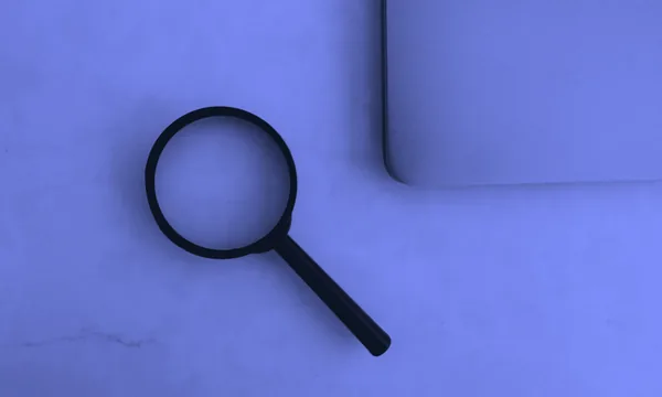 Looking through a magnifying glass to find hidden details
