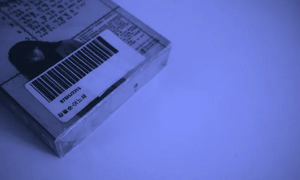 A barcode scanner reading a price tag, symbolizing the cost measurement of digital tokens.