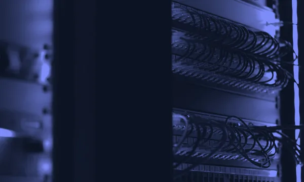 A messy, chaotic wiring system in a server room representing undocumented code