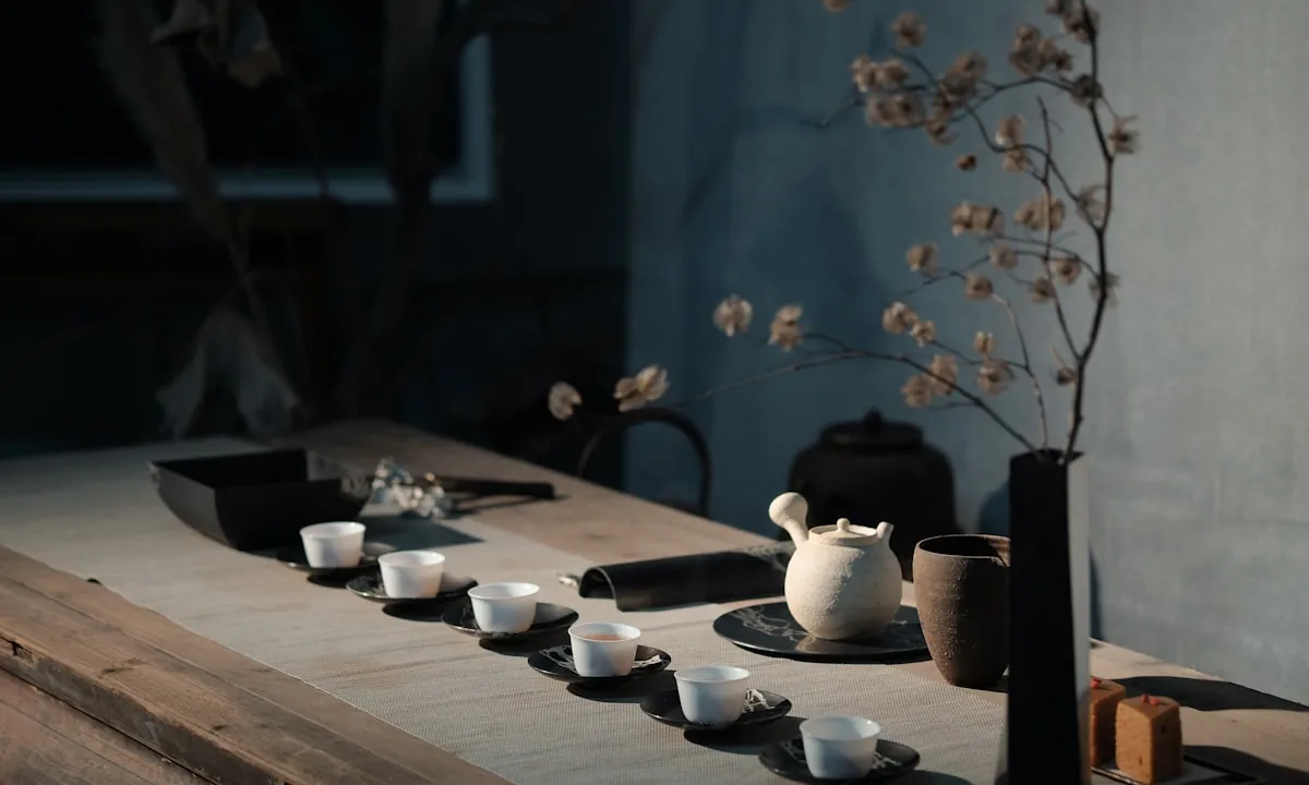 A solitary ceramic tea cup sitting on a mossy stone table