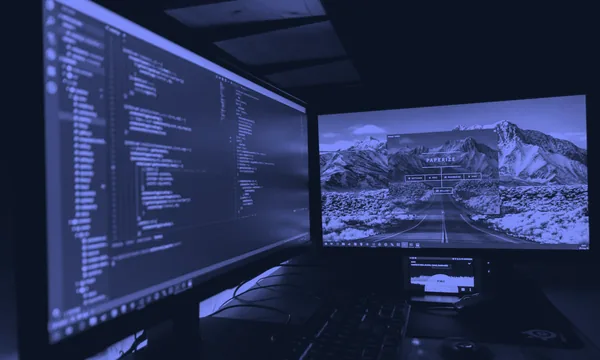 Developer reviewing complex code flow on multiple screens