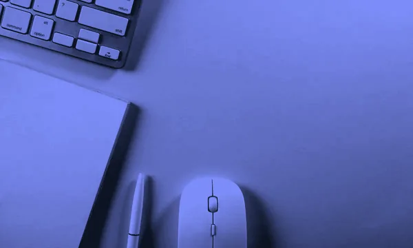 A minimalist white notebook with a pen on a clean desk