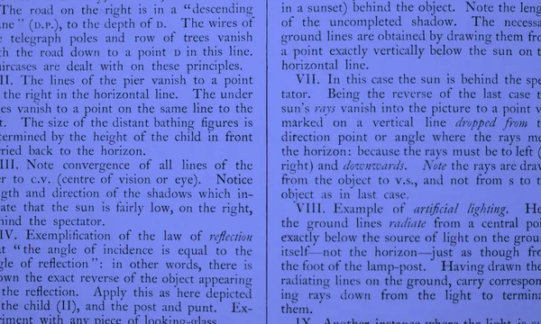 Printed text undergoing detailed scrutiny under magnification