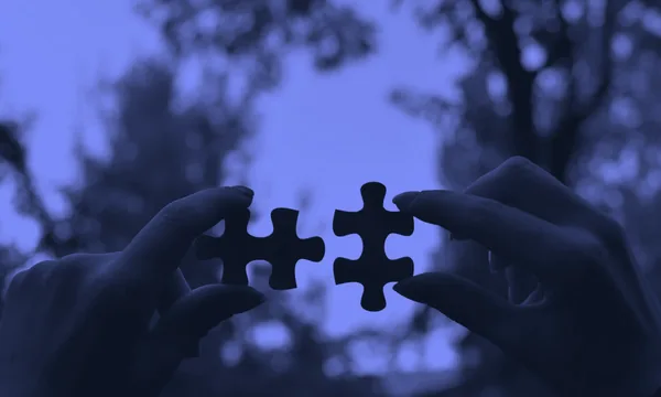 A person solving a complex puzzle representing cognitive struggle