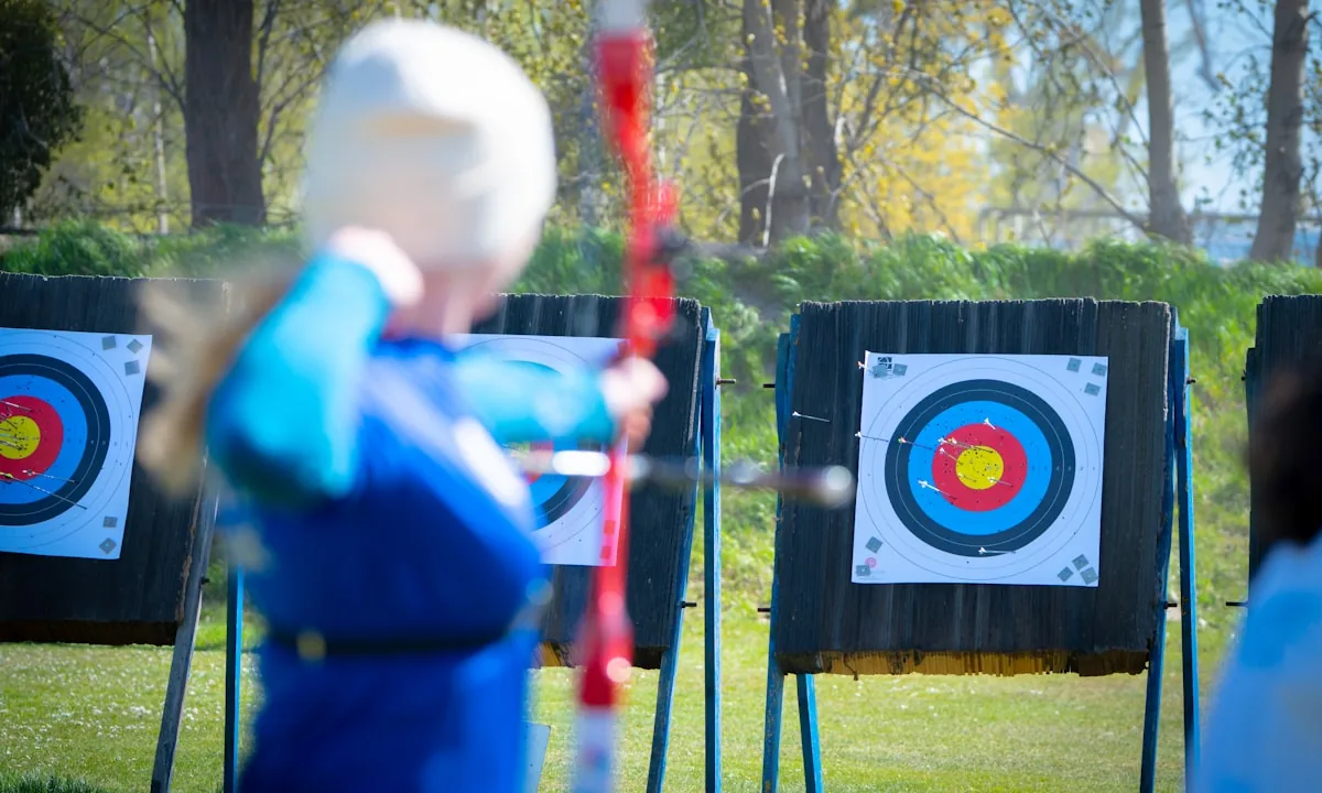 An archer holding a bow aimed at a distant target